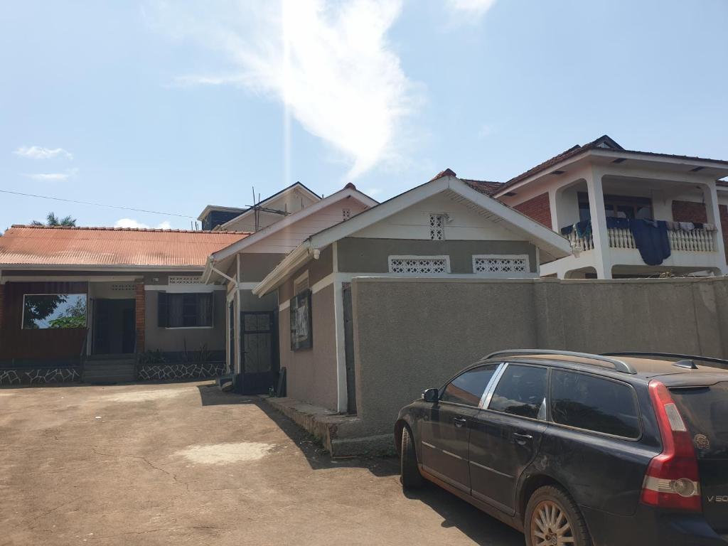 a car parked in front of a house at KBK COMFORT Accommodation in Kampala