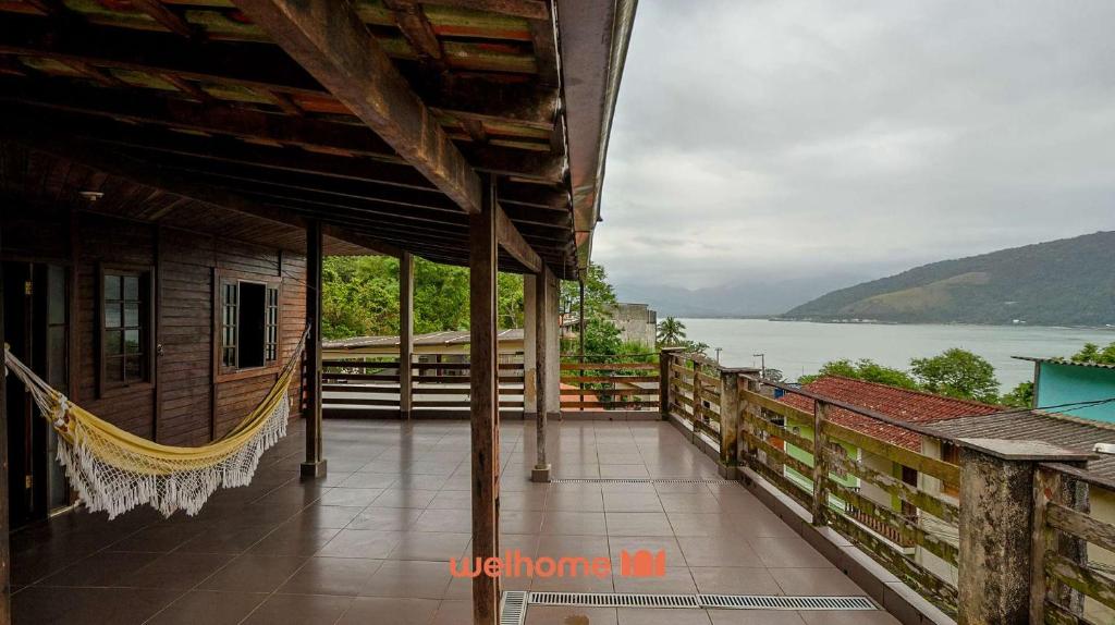 a balcony of a house with a view of the water at Casa em Mangaratiba com 3 suites e Vista Mar in Mangaratiba