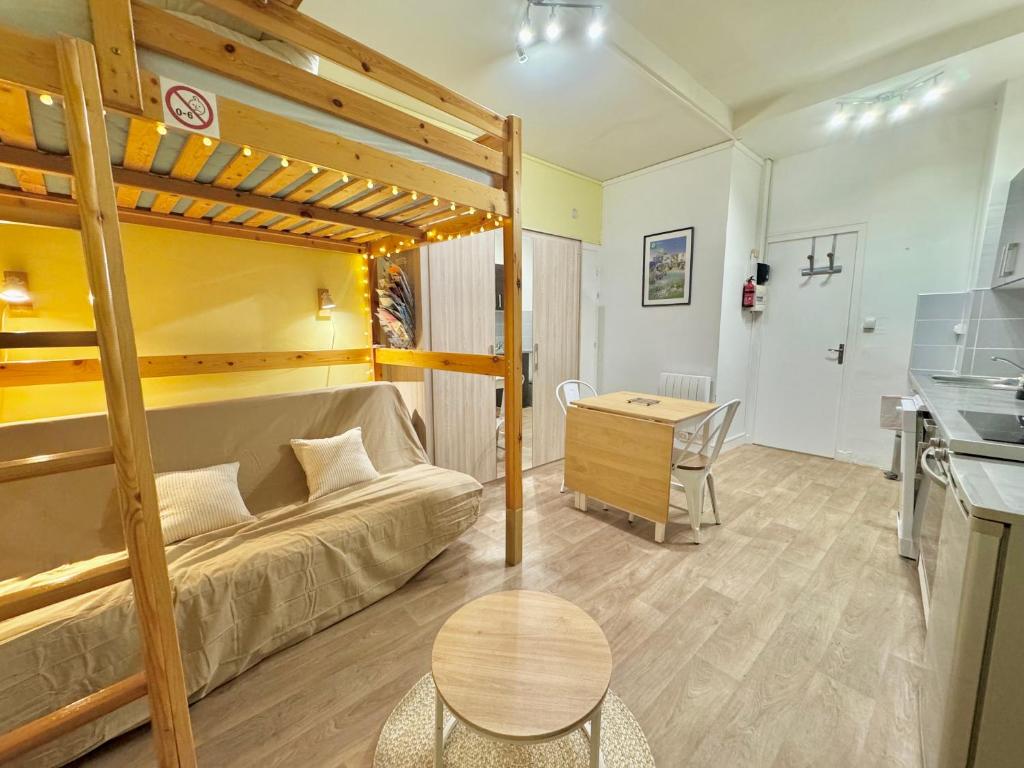 a living room with a bunk bed and a desk at Le Desman des Neiges - Studio confort plein centre in Cauterets