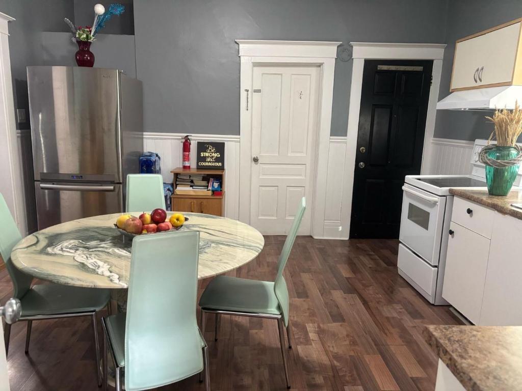 a kitchen with a table with a bowl of fruit on it at Woodbridge Heritage Home in Vaughan