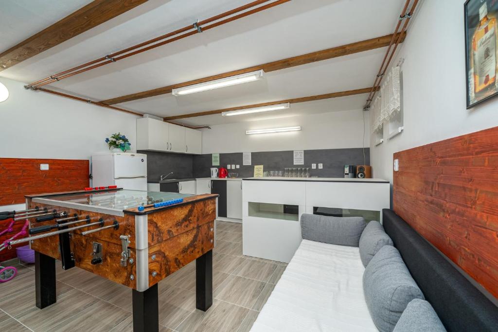 a kitchen and living room with a ping pong table at Apartmany Agatha in Loučná nad Desnou