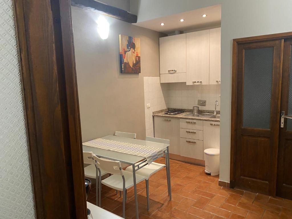 a kitchen with a table and chairs in a room at La Pieve di Luca in La Spezia