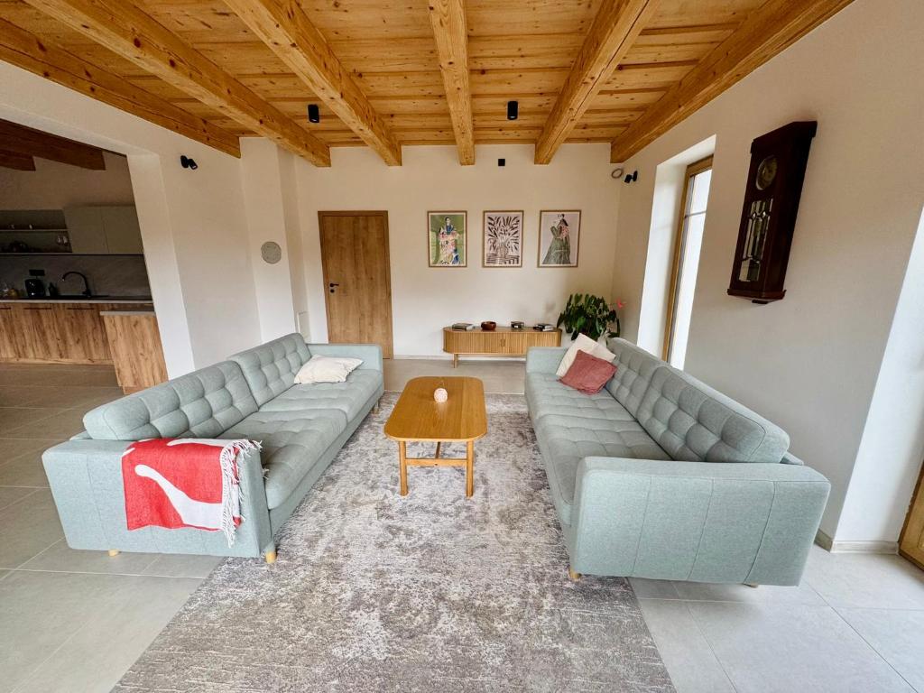 a living room with two couches and a table at Chata pod Jabloňou in Banská Štiavnica