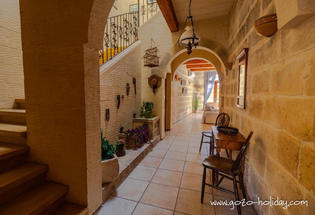 a hallway with a table and chairs in a building at Tal Lilly Xaghra in Xagħra