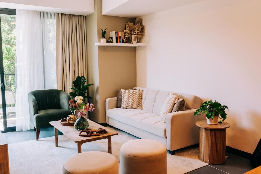 a living room with a couch and a table at NEW Cozy&Modern Apt 30min from SurfCity in Hacienda Plan de La Laguna