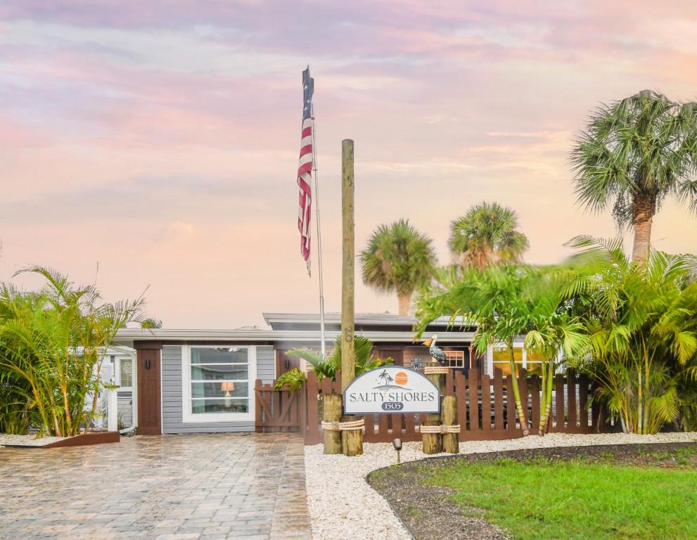 a house with an american flag in front of it at Salty Shores Secluded Oasis in Englewood