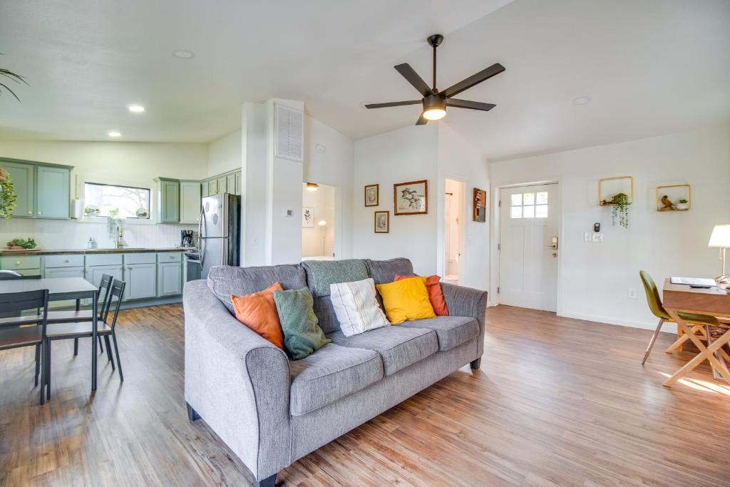 a living room with a gray couch and a kitchen at Deck and Boat Dock Lakefront Cabin in Eucha! in Eucha