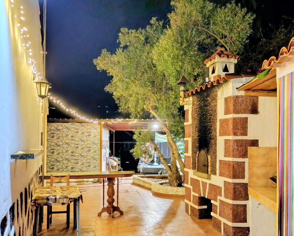 a patio with a table and a string of lights at Villa Margarita in Santa Lucía