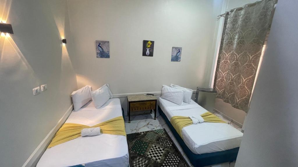 a small room with two beds in it at One Season Cairo in Cairo