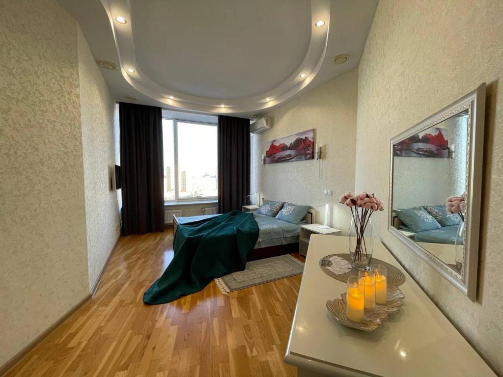 a living room with a couch and a table at Мост сити АПП 52 Джакузи in Dnipro