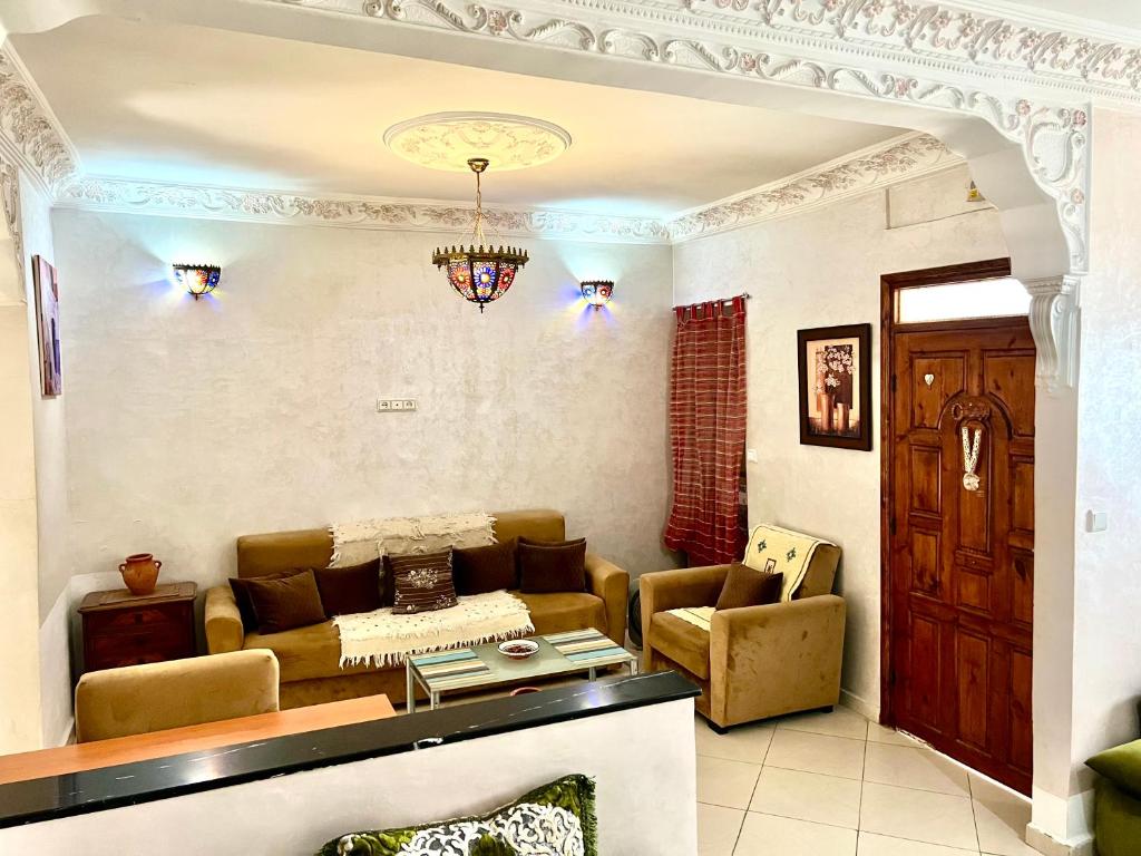 a living room with a couch and a table at appartement traditional cozy in Tangier