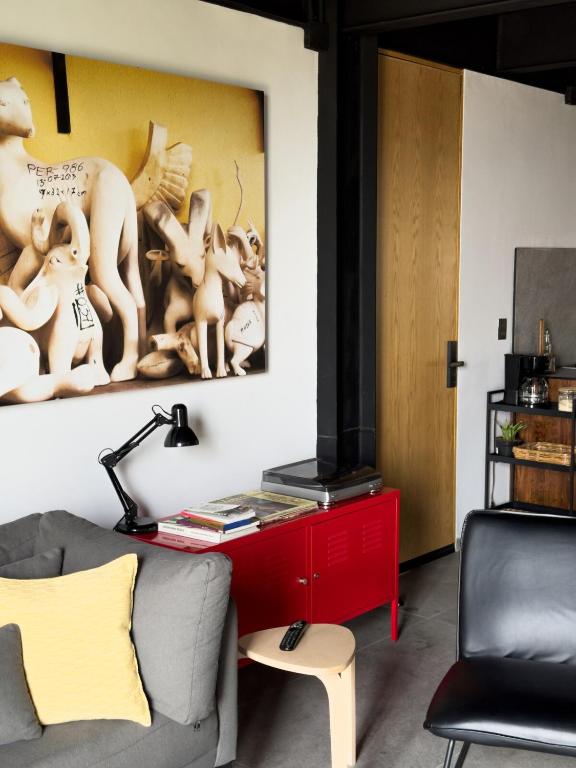 a living room with a couch and a red cabinet at Upscale 2BR 2BA Apt w incredible Mountain Views in Oaxaca City