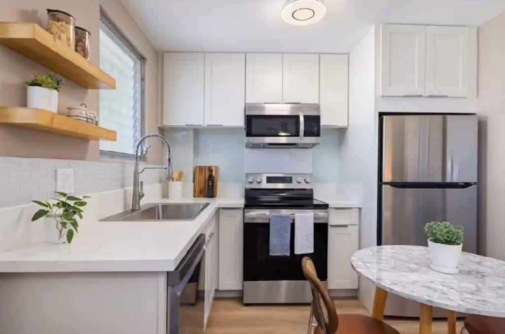 a kitchen with a sink and a stove top oven at One Bed Honolulu Kaaha in Honolulu