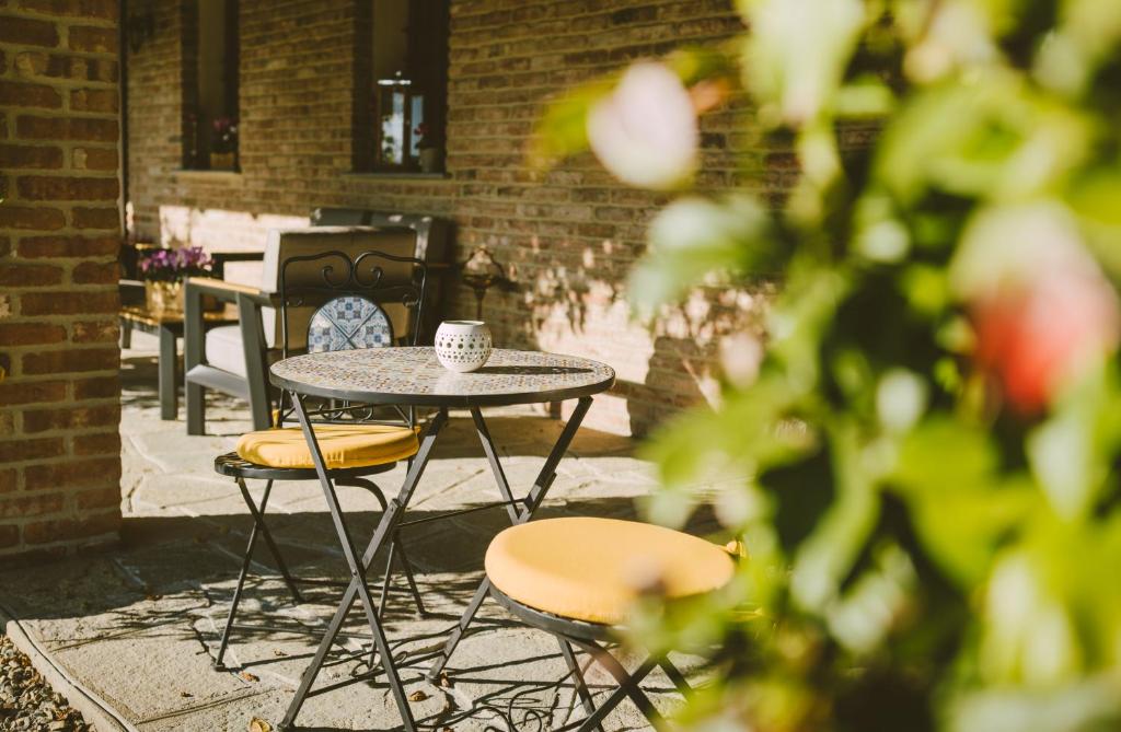 a table and chairs and a coffee cup on a patio at Casa Nizza D'Oro in Castelnuovo
