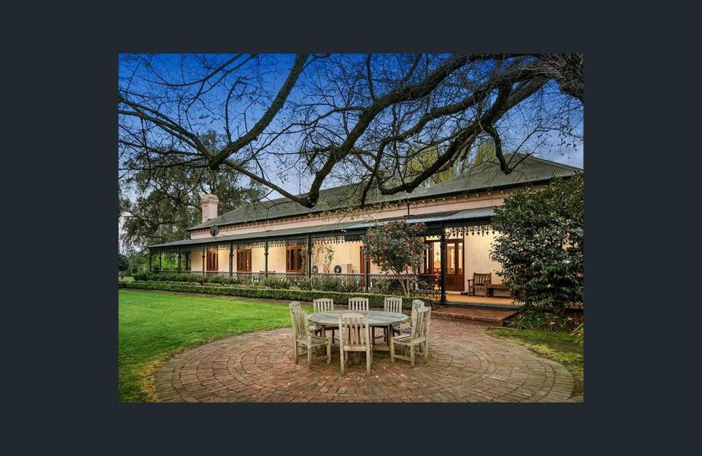 a table and chairs in front of a building at Nook horse farm in Nagambie