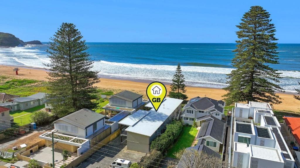a house with a speed sign in front of a beach at Ocean Sunrise - Magical in Avoca Beach