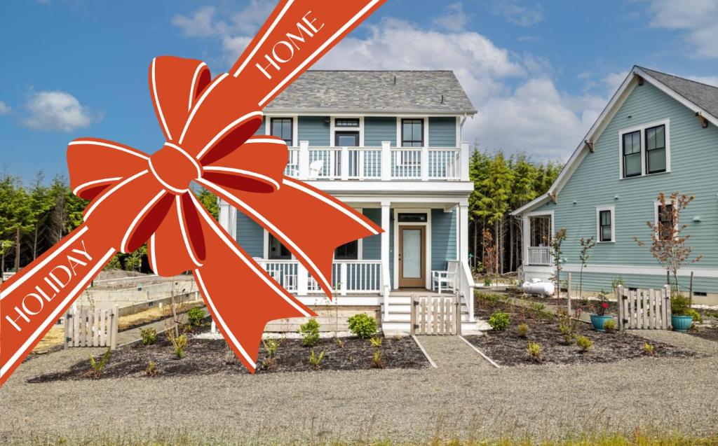 a house with a large red bow in front of it at Starry Meadow by Seabrook Hospitality in Pacific Beach