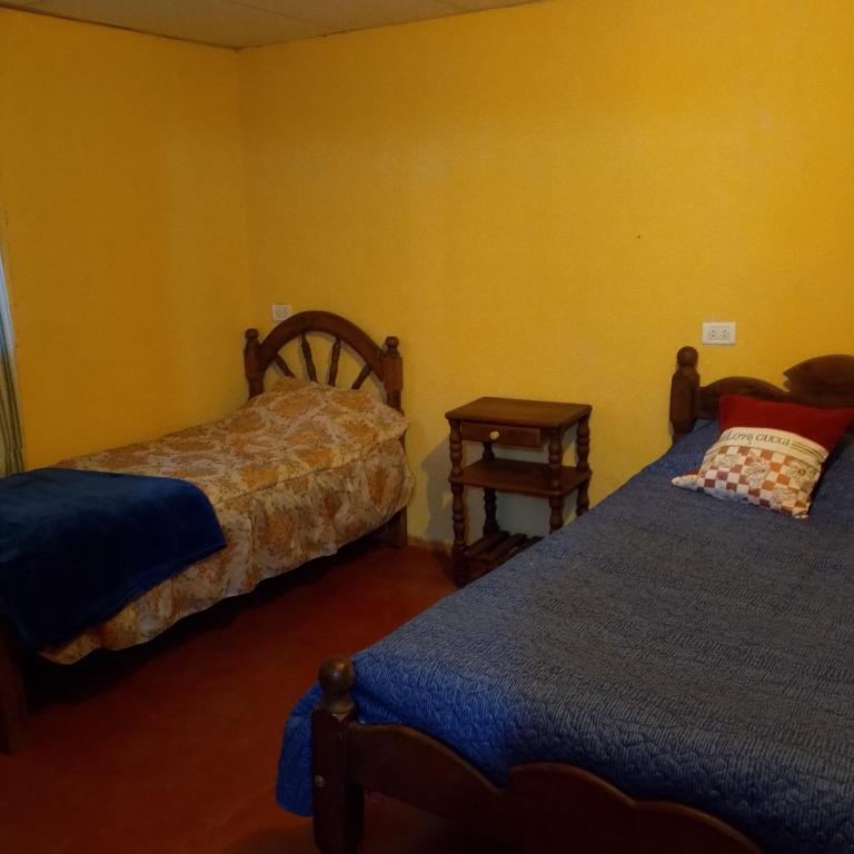 En eller flere senge i et værelse på Apart hotel La estepa