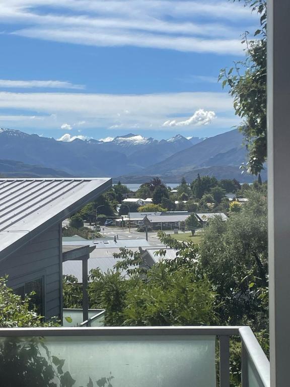 a view of the mountains from the balcony of a house at Sunny Bob Lee Place in Wanaka