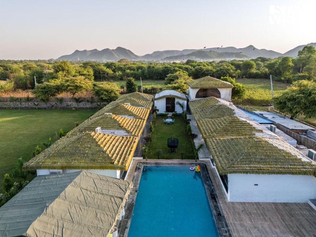 an aerial view of a house with a swimming pool at StayVista at Rissaca Crown with Bonfire in Jaipur