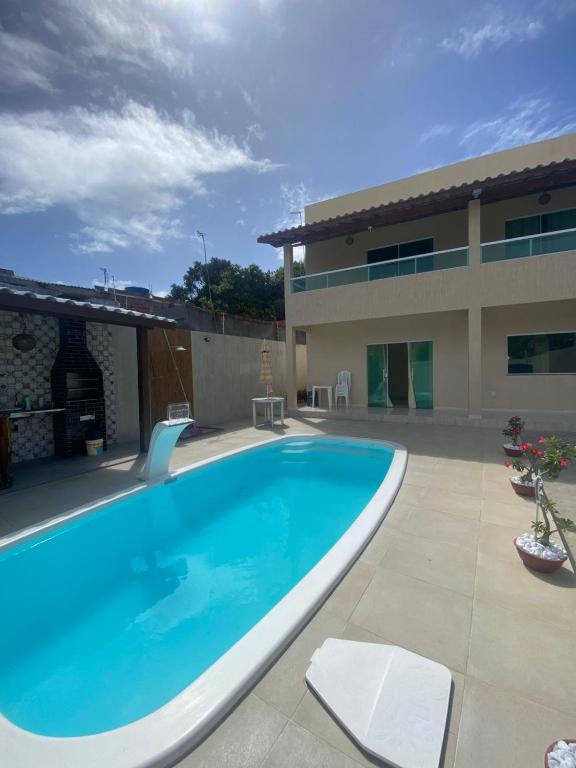 a large swimming pool in front of a building at Casa do Pepe em Barra de Jacuípe in Camaçari
