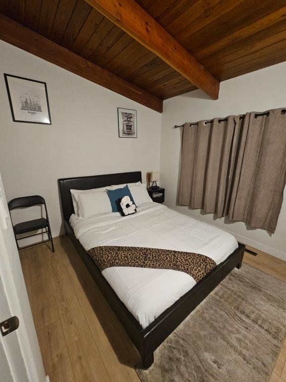 a bedroom with a bed with a panda pillow on it at P&N Suites - Queen Room- DUBAI in Edmonton