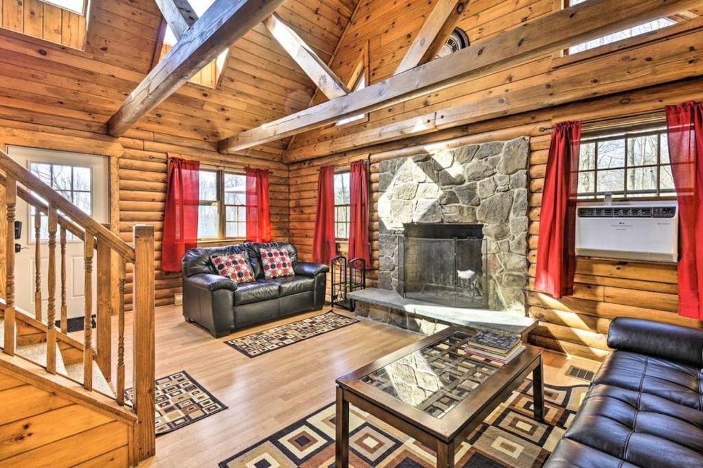 a living room with a fireplace in a log cabin at Log Cabin Luxury Fire Pit Nights Autumn Midweek - 35 Off Promo! in Pleasant Mount