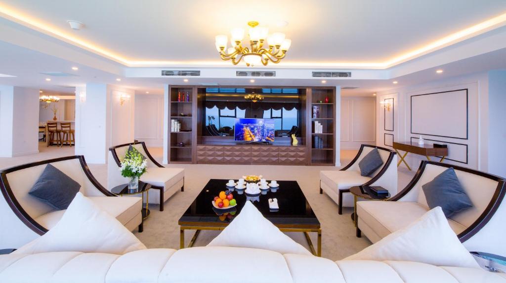 a living room with white furniture and a chandelier at Muong Thanh Luxury Da Nang Hotel in Danang