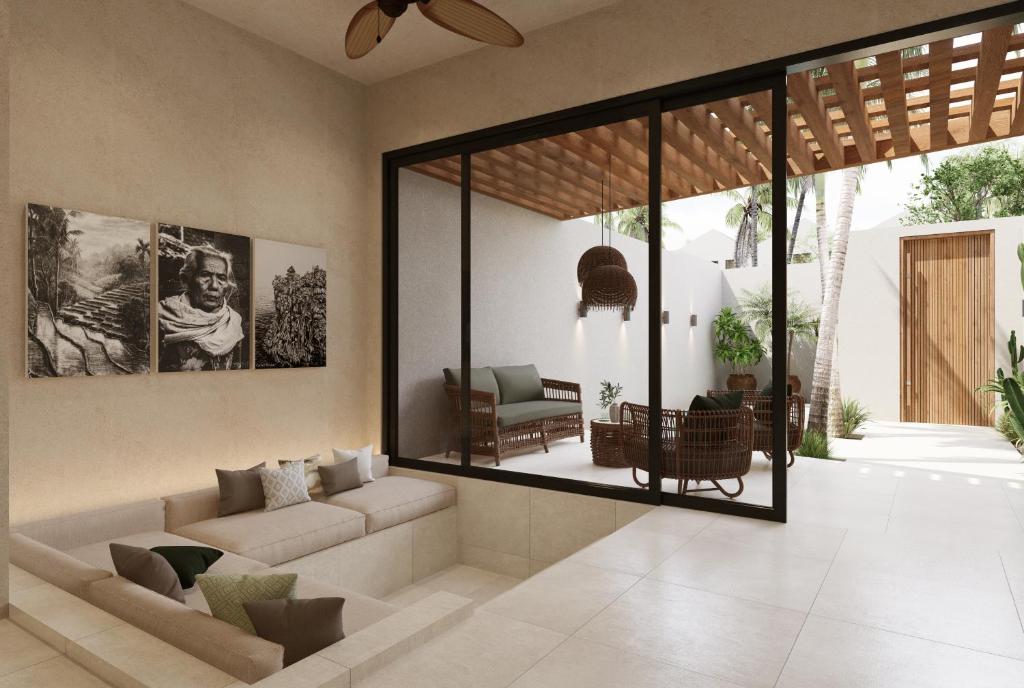 a living room with a couch and a large mirror at New Luxury Ribamar Villas in Uluwatu