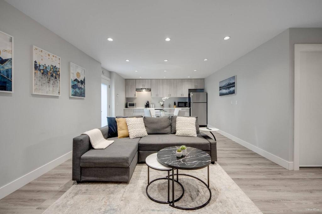 a living room with a couch and a table at Spacious 1BR Suite Near Capilano Bridge & Trails in North Vancouver