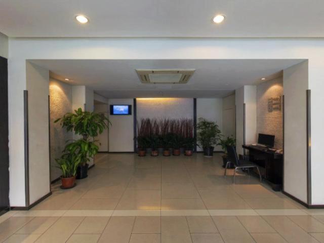 an empty hallway with potted plants in an office building at Jinjiang Inn Shanghai Lu Jiabang Road in Shanghai