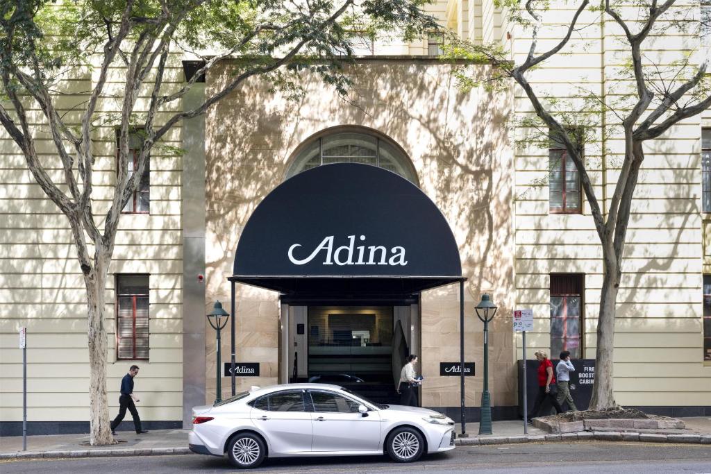a white car parked in front of aania store at Adina Apartment Hotel Brisbane Anzac Square in Brisbane