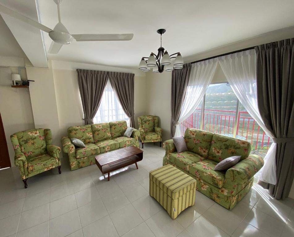 a living room with a couch and chairs and a table at Jo’s Place Cameron Highlands EA922 in Brinchang