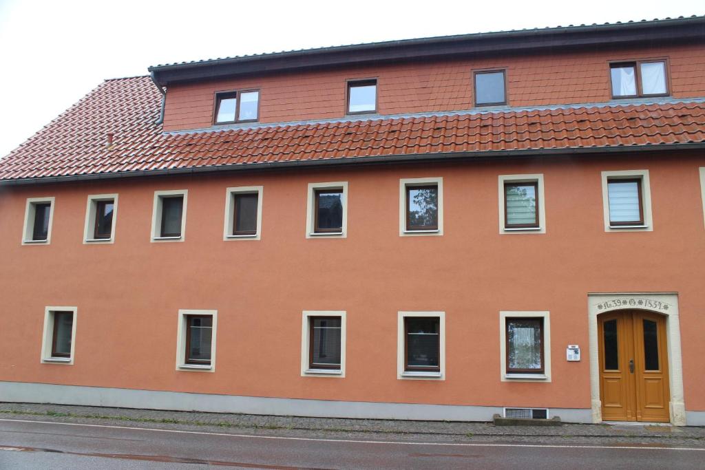 a orange building with a red roof at Ferienapartment Horn in Sebnitz