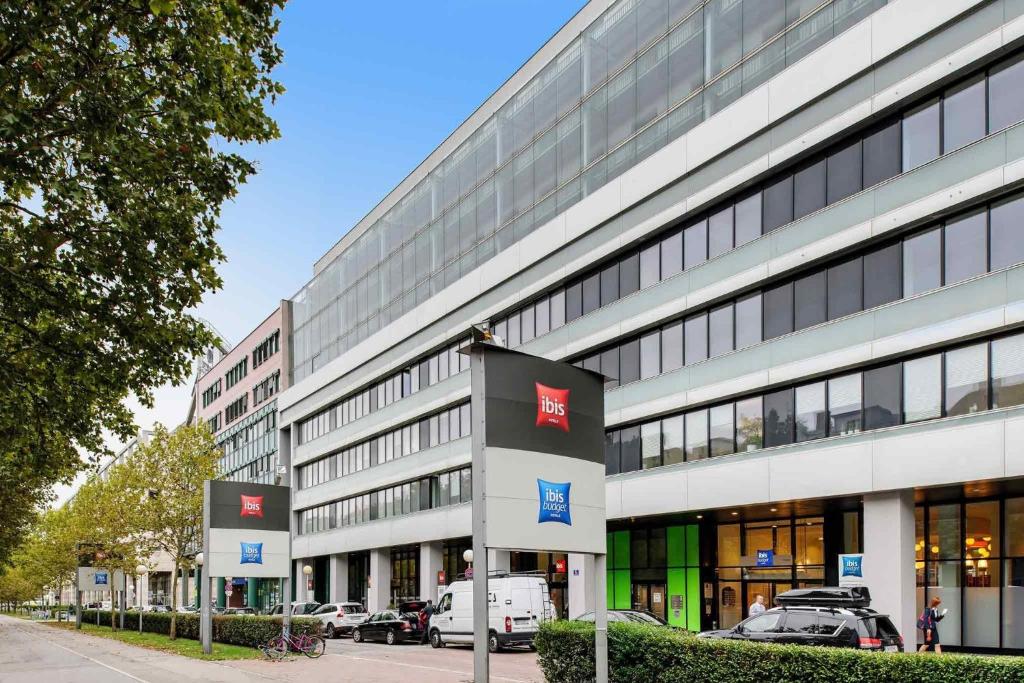 a large building with a sign in front of it at Ibis budget Wien Messe in Vienna