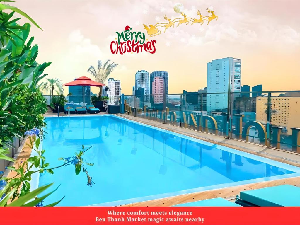 a large swimming pool on the roof of a building with a city skyline at Happy Life Grand Hotel & Rooftop Skybar in Ho Chi Minh City