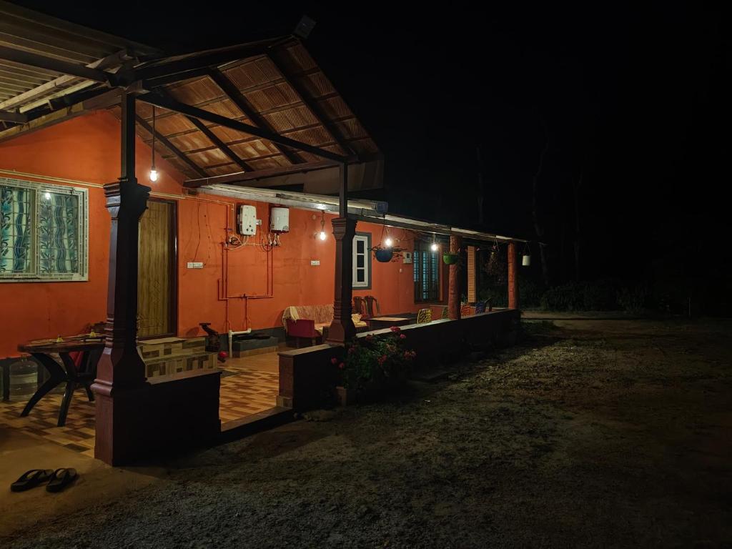 a house with a porch at night at Himagni Homestay - Entire Villa in Sakleshpur