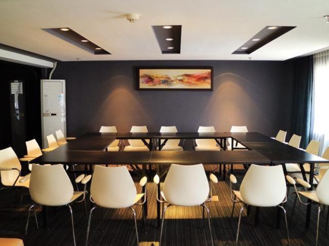 a conference room with a large table and white chairs at Jinjiang Inn Wenling Daxi in Wenling