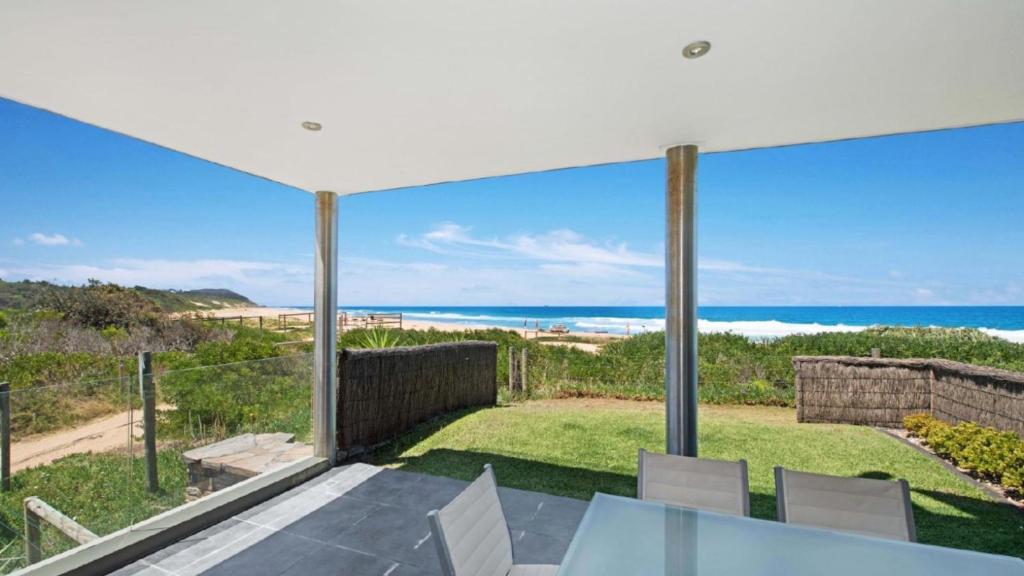 a view of the ocean from the balcony of a house at The Pavillion 1 - Beachfront in Wamberal
