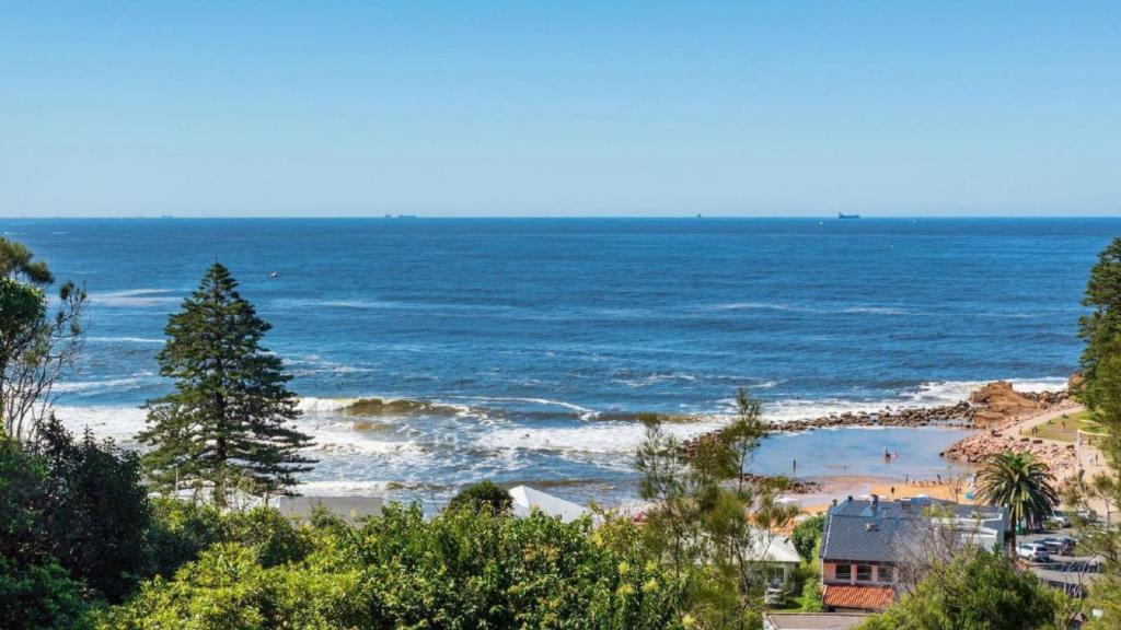 a view of a beach with people in the water at Point View - 'amazing Views =& Location=' in Avoca Beach