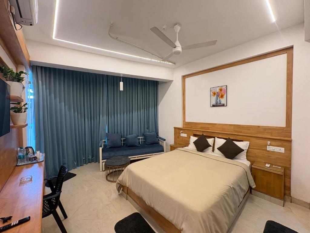 a hotel room with a bed and a couch at Sandcastle Resort in Varkala