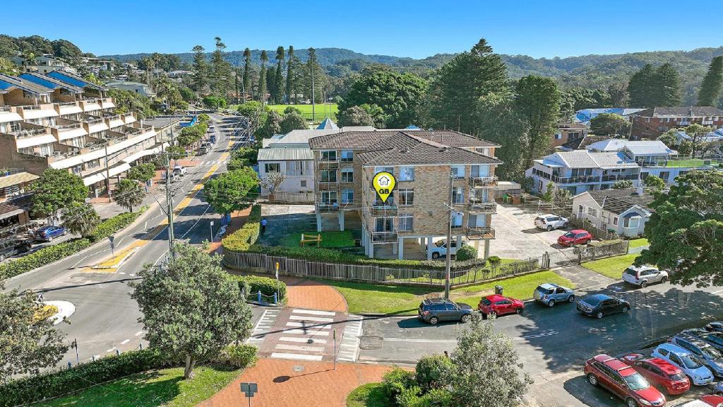 an aerial view of a city with cars parked in a parking lot at Seaview 7 - Prime Position Beachside Holiday in Avoca Beach