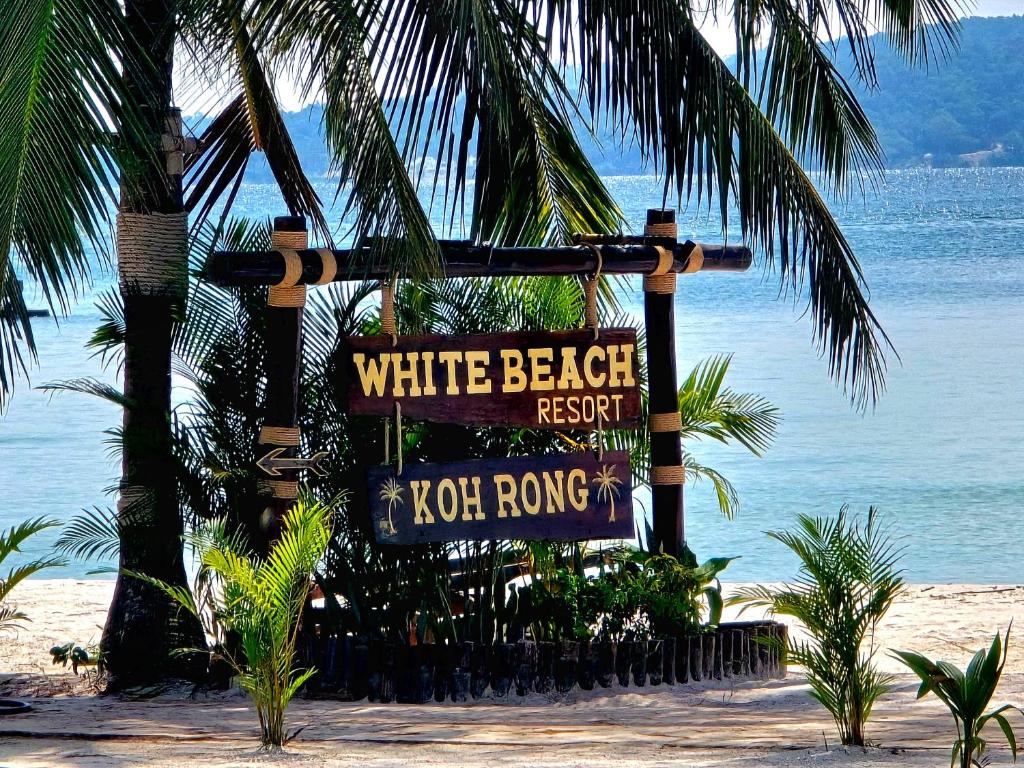 a sign for a white beach restaurant on the beach at White Beach Resort Longset in Koh Rong Island