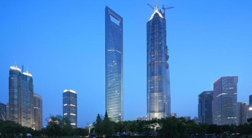 a group of tall skyscrapers in a city at Ramada by Wyndham Wujiaochang Shanghai in Shanghai