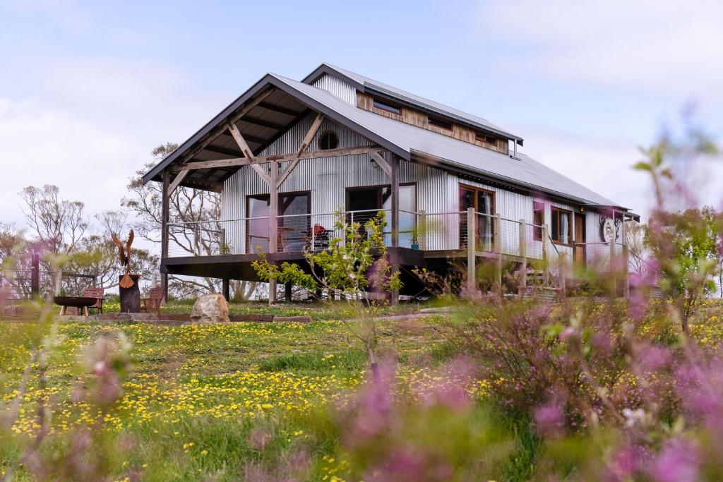 an old house in the middle of a field at The Barn at Piney Ridge Farm - Bed & Breakfast in Nairne