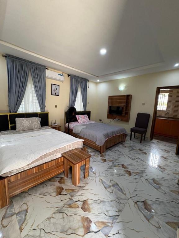 a bedroom with two beds and a tv in it at Bollington ADEX house 