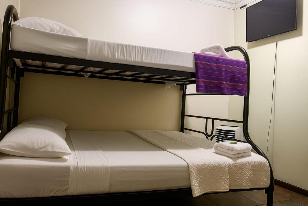 Postel nebo postele na pokoji v ubytování Hotel el Tucan Alajuela