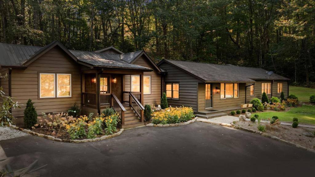 a house with a landscaping in front of it at Dahlia House, 3 BDRM Walk To Town in Highlands