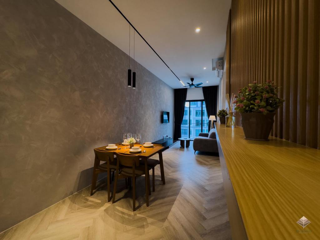 a dining room with a table and chairs at Rumaho Upton by Elica Kuching in Kuching