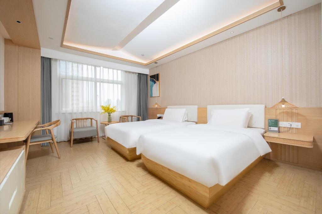 Postel nebo postele na pokoji v ubytování Zhengzhou Agricultural University, Henan Provincial Museum, Meilun Hotel
